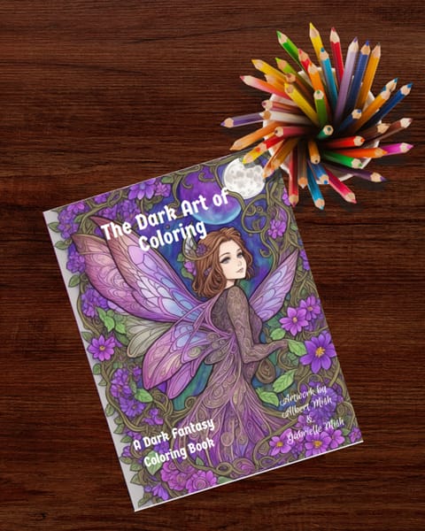 A Dark Fantasy Coloring Book displayed on a wooden table with a cup of colored pencils