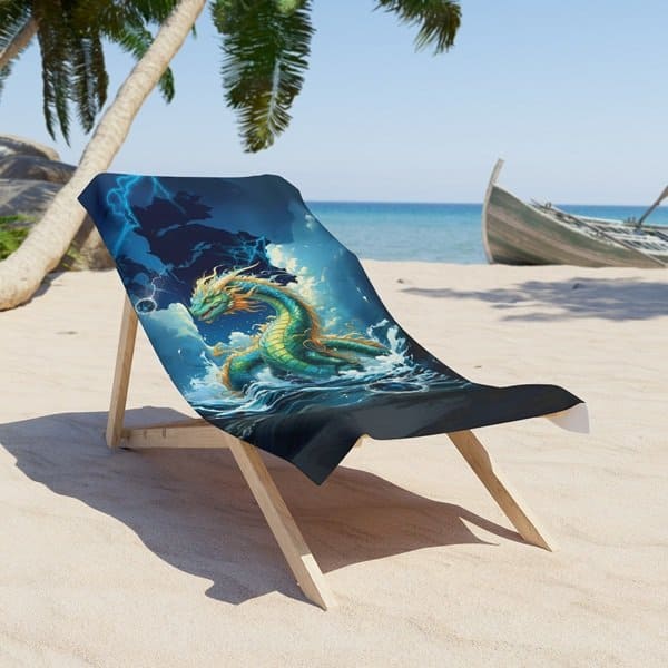 Water Dragon Beach Towel draped across a beach chair on the sand